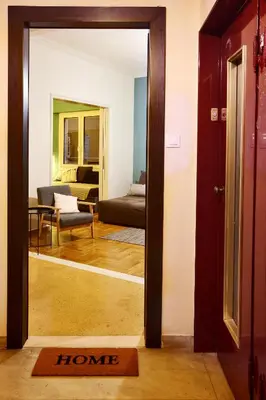 a room with a door open to a living room at Athens Centre Apartment in Athens