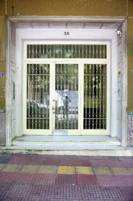 a door with a gate in front of a building at Athens Centre Apartment in Athens
