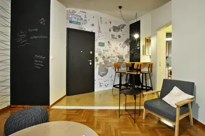 a room with a black door and chairs and a table at Athens Centre Apartment in Athens