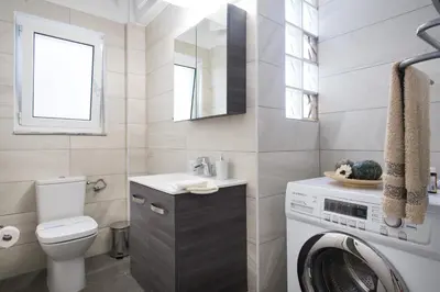 a bathroom with a washing machine and a washer at Alexander's Penthouse in Athens