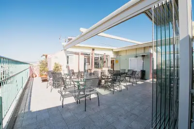 a patio with chairs and tables on a balcony at Safestay Athens Monastiraki in Athens