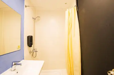 a bathroom with a shower curtain and a sink at Safestay Athens Monastiraki in Athens