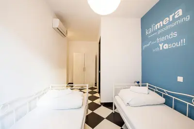 two beds in a room with a checkered floor at Safestay Athens Monastiraki in Athens