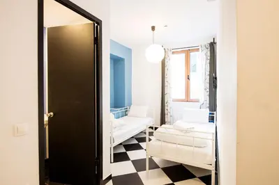 a living room with a couch and a mirror at Safestay Athens Monastiraki in Athens