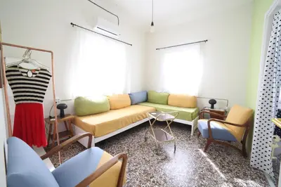a living room with a couch and two windows at Sun sto Spiti in Athens