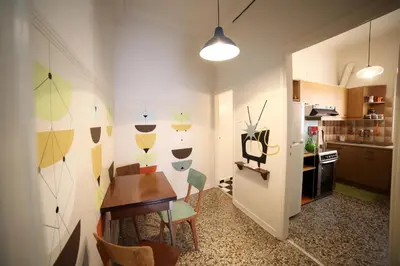 a kitchen with a table and chairs in a room at Sun sto Spiti in Athens