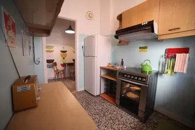 a small kitchen with a stove and a refrigerator at Sun sto Spiti in Athens