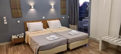 a bedroom with a bed with two towels on it at Ariston Hotel in Athens