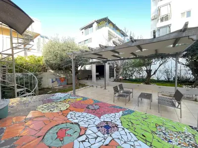 a patio with a mosaic floor with a pergola at Aquarius - Glyfada detached house in Athens