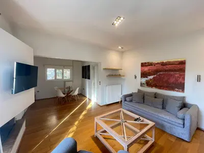 a living room with a couch and a table at Aquarius - Glyfada detached house in Athens
