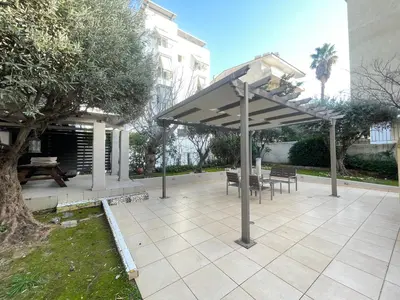 a pavilion with a table and chairs under a canopy at Aquarius - Glyfada detached house in Athens