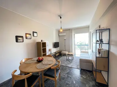 a living room with a table and a couch at Archer - Sea view apartment in Athens