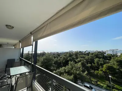 a balcony with a view of trees at Archer - Sea view apartment in Athens