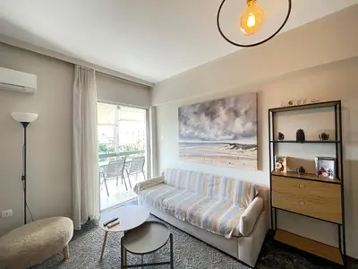 a living room with a couch and a table at Archer - Sea view apartment in Athens