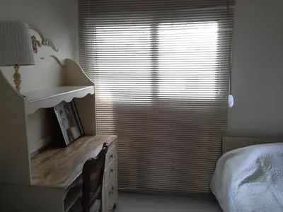a bedroom with a window with a sink and a dresser at Apartment near the Beach in Athens