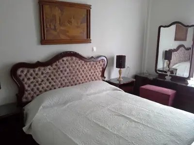 a bedroom with a bed and a large mirror at Apartment near the Beach in Athens