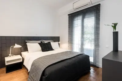 a bedroom with a large bed and a window at Executive 2 bdr Suite in Plaka - Acropolis view in Athens