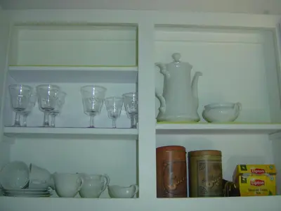 a shelf with glasses and cups and a tea pot at Medea in Athens