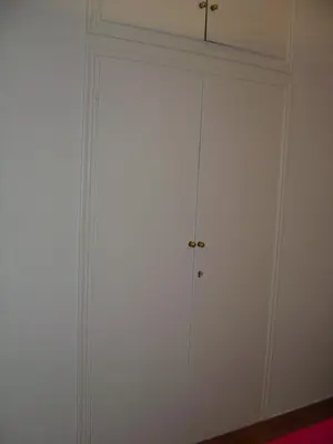 a white closet with a door in a room at Medea in Athens