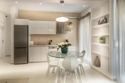 a kitchen with a table and chairs and a refrigerator at Acropolis Museum - Modern Living [I] in Athens