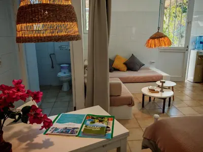 a living room with a couch and a table at Oneiro glico in Agia Marina Aegina