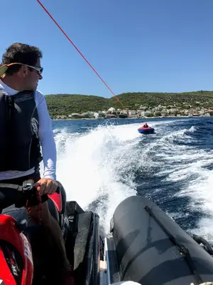 a man on a boat in the water at Oneiro glico in Agia Marina Aegina