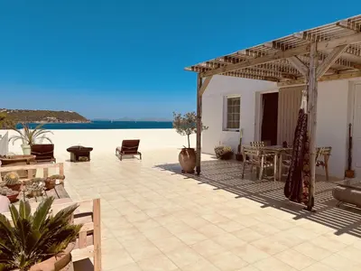 a large patio with a view of the beach at Oneiro glico in Agia Marina Aegina