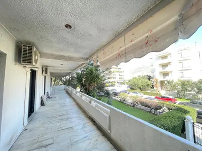 a balcony of a building with a view of a street at Aries - Glyfada City Center Apartment in Athens