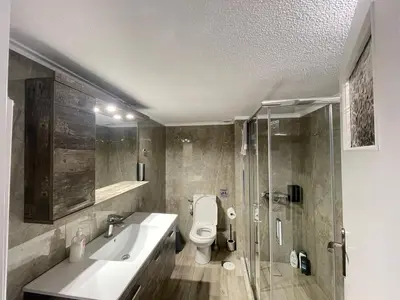 a bathroom with a toilet and a sink and a shower at Aries - Glyfada City Center Apartment in Athens