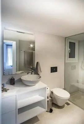 a bathroom with a sink and a toilet and a mirror at Acropolis Museum - Modern Living [II] in Athens