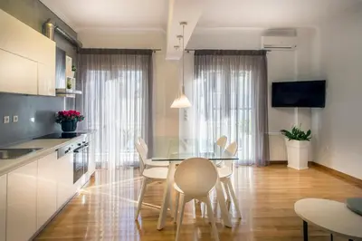 a kitchen and dining room with a table and chairs at Acropolis Museum - Modern Living [II] in Athens