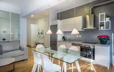 a kitchen with a glass table and white chairs at Acropolis Museum - Modern Living [II] in Athens