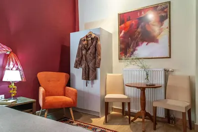 a room with chairs and a coat hanging on a wall at Zen Hotel in Athens