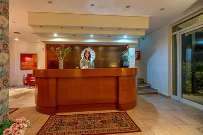 a reception desk in a lobby with a picture of a woman at Zen Hotel in Athens