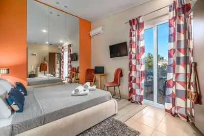 a bedroom with a bed and a room with a balcony at Zen Hotel in Athens