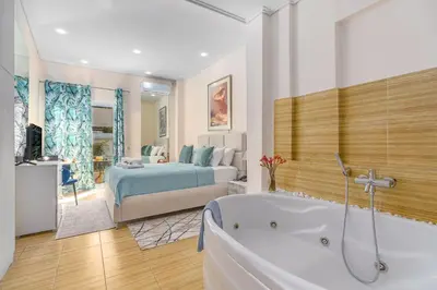 a bathroom with a tub and a bedroom with a bed at Zen Hotel in Athens