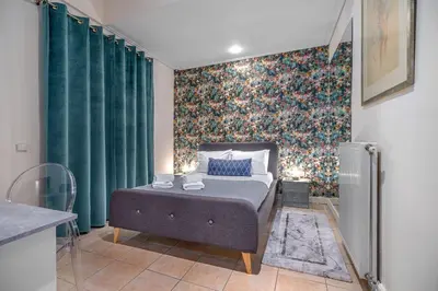 a bedroom with a bed and a wall with green curtains at Zen Hotel in Athens