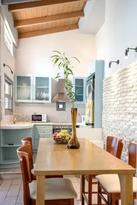 a kitchen with a wooden table with a vase on it at Valashouse in Athens