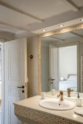 a bathroom with a sink and a large mirror at Valashouse in Athens