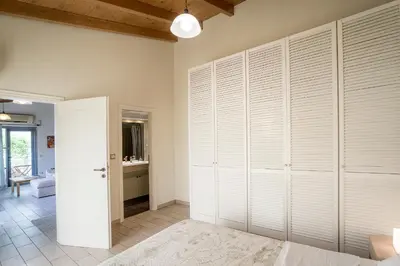 a bedroom with white closets in a room at Valashouse in Athens