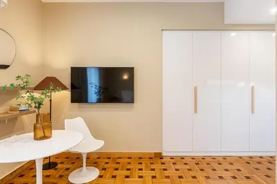 a white dining room with a white table and white cabinets at Kolonaki Suites by Olala Homes in Athens