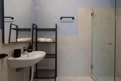 a bathroom with a sink and a shower at Kolonaki Suites by Olala Homes in Athens