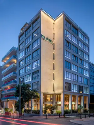 a tall white building on a city street at Casual Kubic Athens in Athens