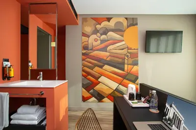 a bathroom with a sink and a painting on the wall at Casual Kubic Athens in Athens