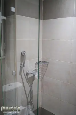 a shower in a bathroom with a glass door at Mansion Hotel in Athens