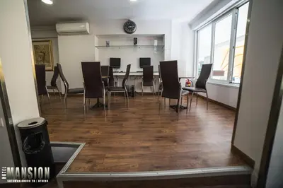 a dining room with a table and chairs at Mansion Hotel in Athens