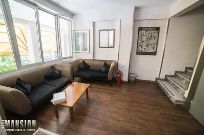 a living room with a couch and a table at Mansion Hotel in Athens