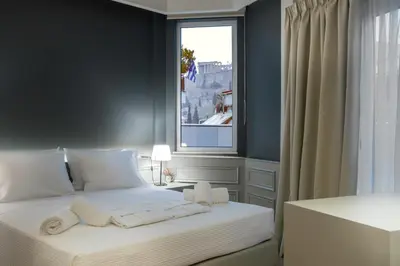a bedroom with a bed with towels on it at AD Athens Luxury Rooms & Suites in Athens