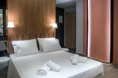 a bedroom with a bed with two towels on it at AD Athens Luxury Rooms & Suites in Athens