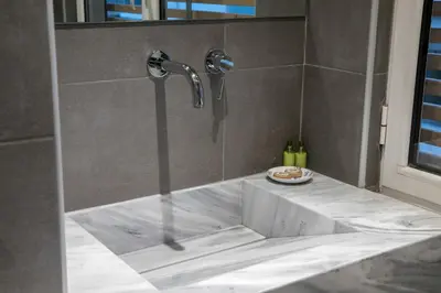 a shower in a bathroom with a sink at AD Athens Luxury Rooms & Suites in Athens